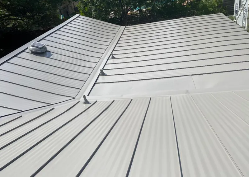 Solar attic fan installed on a metal roof for Roof Ventilation in Billings