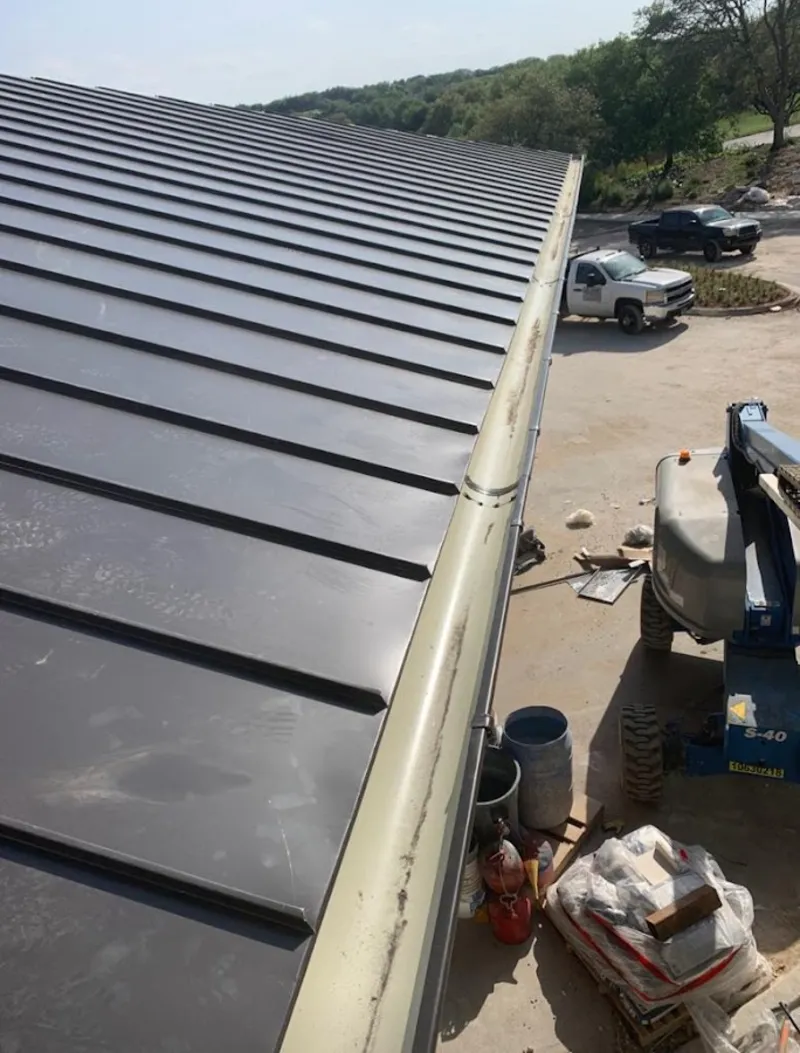 Standing seam panel and gutter detail on a metal roofing jobsite in Billings